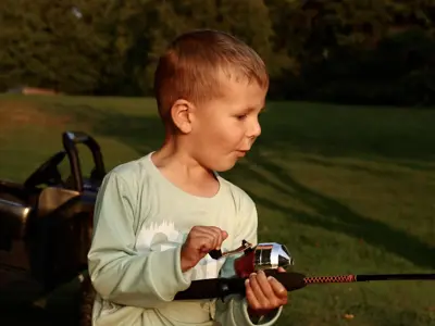 A young child with a fishing pole.