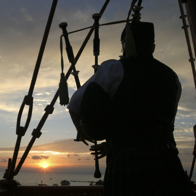 The Phantom Piper playing at sunset over Lake Huron.