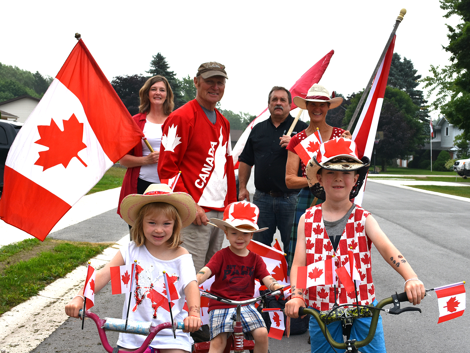 A family dressed in red and white celebrates Canada Day.