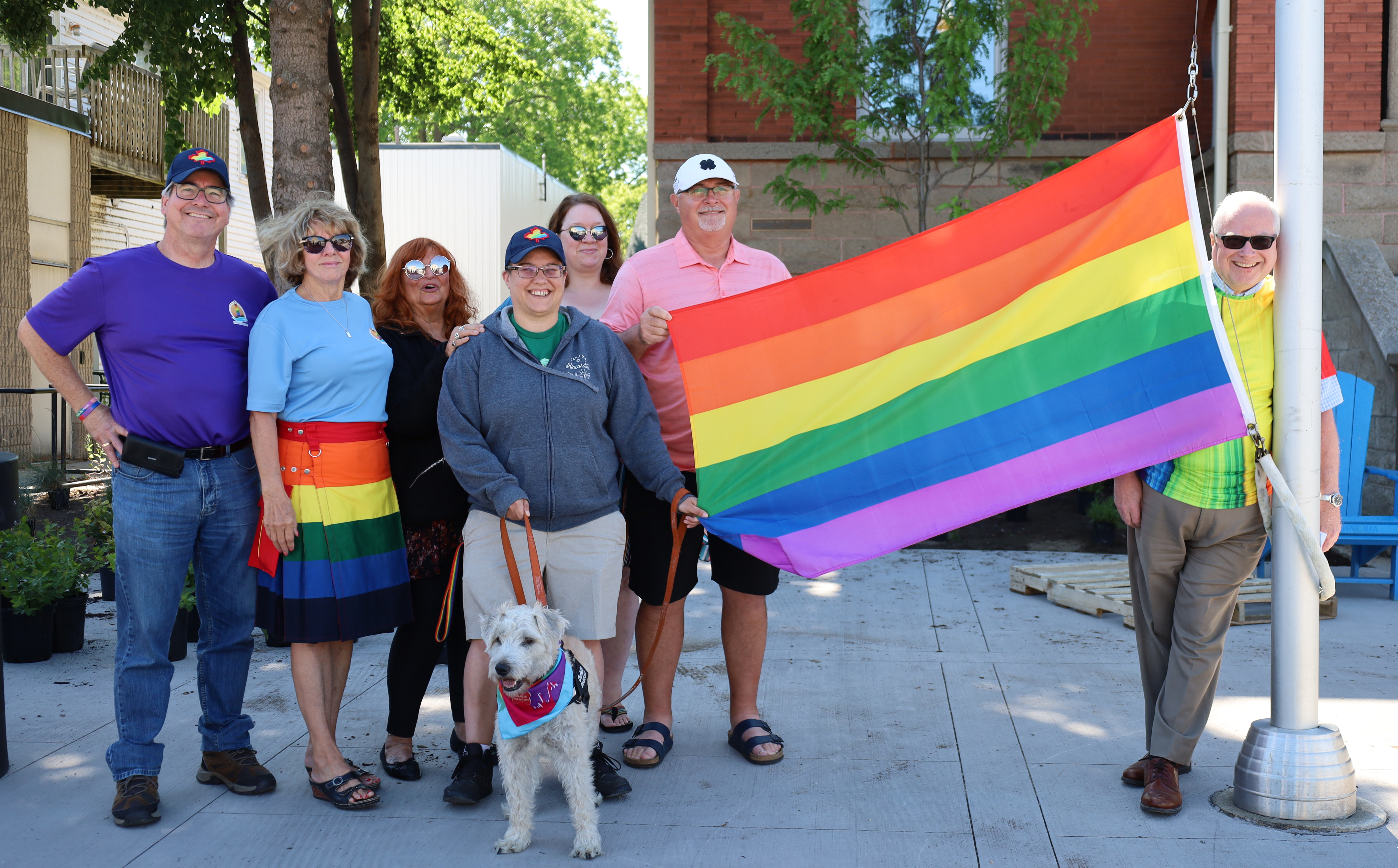 Members of Kincardine Pride gather to raise the Pride Flag.